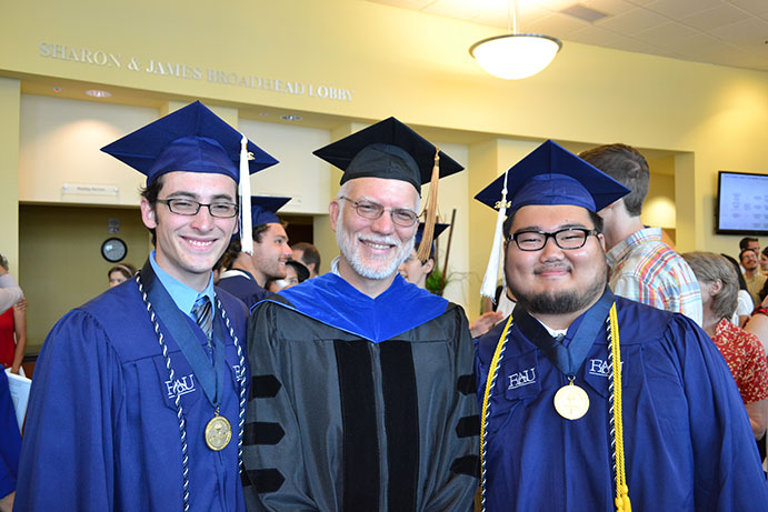 Justin Odom, Prof. Jon Moore, and Tokio Sano at graduation